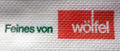 Logo der Bäckerei Wölfel auf einer Serviette, ca. 1990 <span class="smw-highlighter" data-type="8" data-state="inline" data-title="Hinweis" title="Urheber: Bächerei WölfelLizenz: CC BY-SA 3.0"><span class="smwtticon note"></span><span class="smwttcontent">Urheber: Bächerei Wölfel<br><br>Lizenz: CC BY-SA 3.0</span></span>